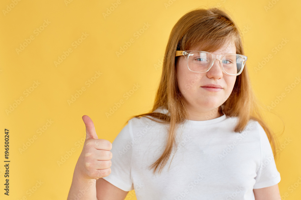 portrait of redhead teen girl on yellow background portrait of redhead teen girl on yellow background