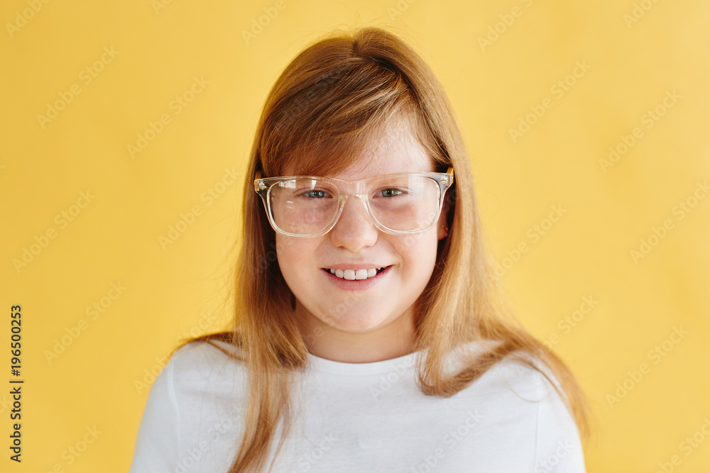 portrait of redhead teen girl on yellow background portrait of redhead teen girl on yellow background