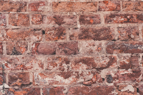 Ancient masonry of weathered bricks close-up - a vintage rough background
