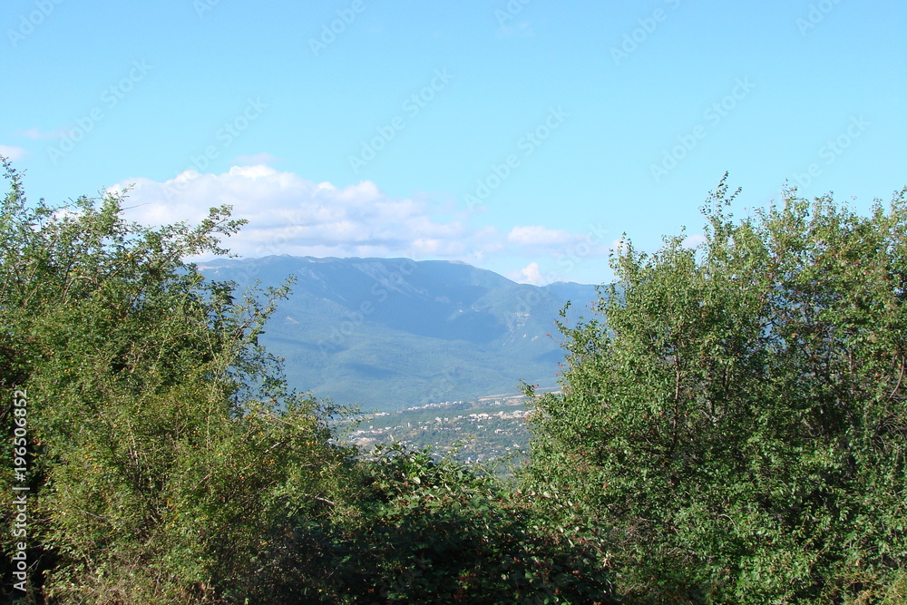a view of the Crimean mountain range and an inhabited valley at its foot.