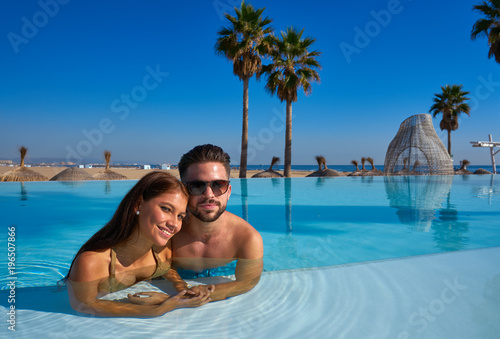 Wallpaper Mural Tourist couple having bath in infinity pool Torontodigital.ca