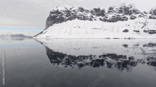 Reflection of GnÌ´lodden in Hornsund in Southwestern Spitsbergen in Svalbard, Norway. photo