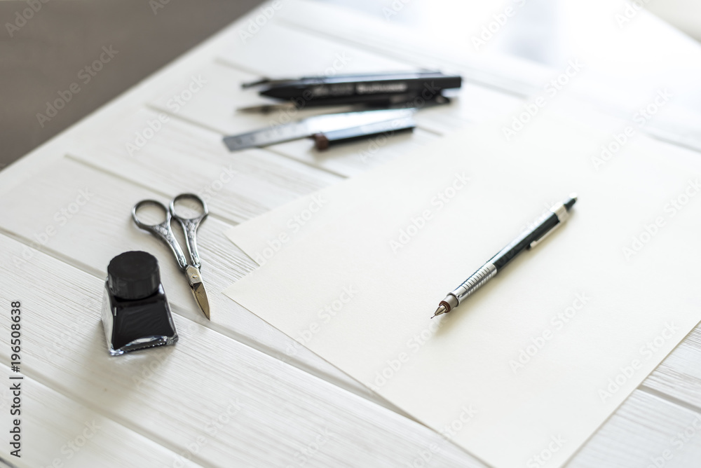 Design studio. Designer's attributes on table: scissors, pencil, pen etc. Design studio. Designer's attributes on table: scissors, pencil, pen etc.