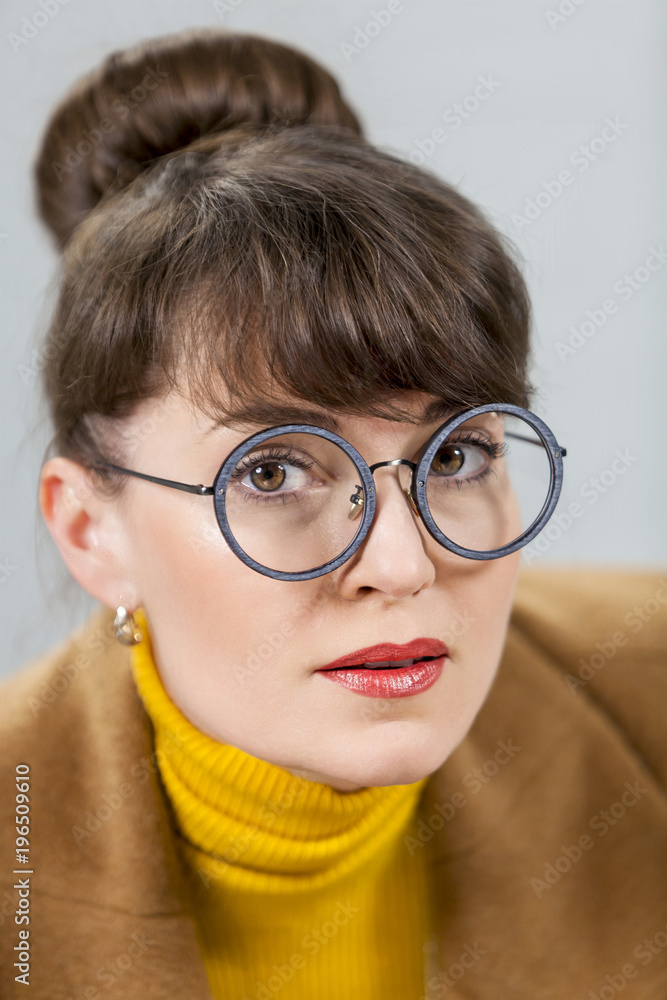 girl with round glasses closeup on grey background girl with round glasses closeup on grey background