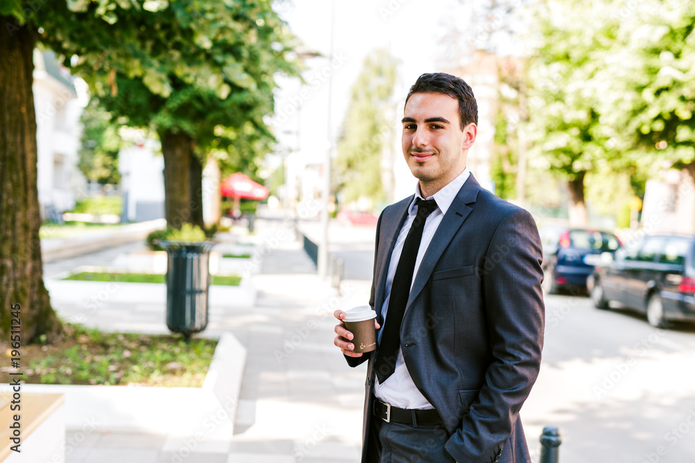 Young businessman take break to drink coffee outdoor