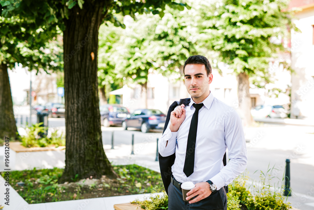 Young businessman take break to drink coffee at the avenue Young businessman take break to drink coffee at the avenue