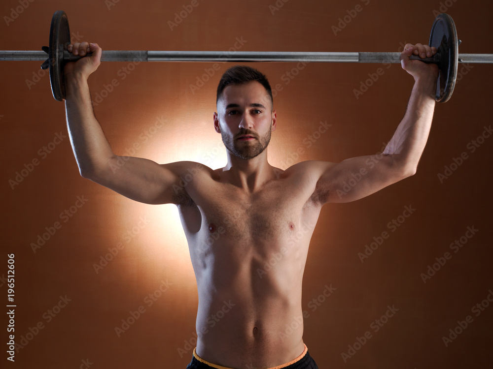 Young man training with weight lifting. Young man training with weight lifting.
