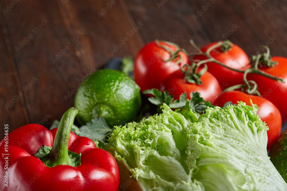 Vegetarian still life of assorted fresh vegetables and herbs on vintage wooden background, top view, selective focus.