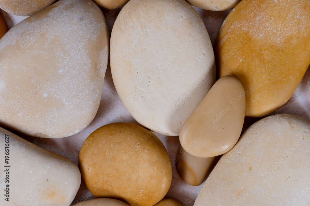 pebbles. clean white brown black pebbles isolated. the pebbles are on white or brown sand. small and large are visible pebbles. clean white brown black pebbles isolated. the pebbles are on white or brown sand. small and large are visible