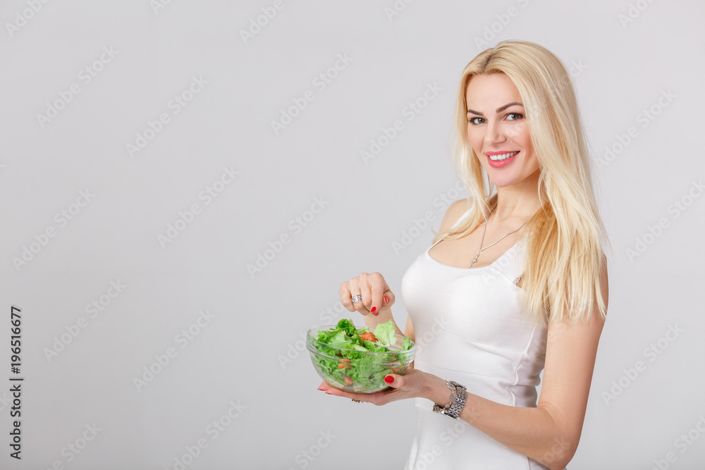 woman in white dress with fresh salad woman in white dress with fresh salad