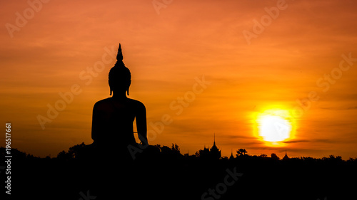 Buddha statue over scenic sunset sky background © PRASERT