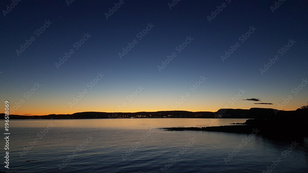 Sunset view on water in Oslofjord and mountains