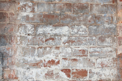 old red brick wall painted with white paint