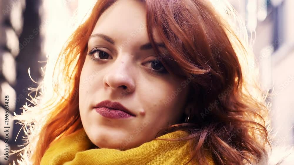 sexy red-haired woman flirting with the camera- outdoor sexy red-haired woman flirting with the camera- outdoor