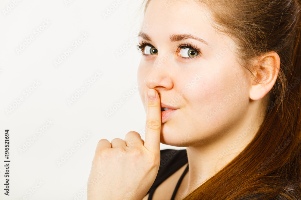 Woman showing silence gesture with finger Woman showing silence gesture with finger