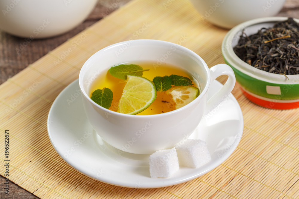 cup of black tea with mint leaves on a wooden table cup of black tea with mint leaves on a wooden table