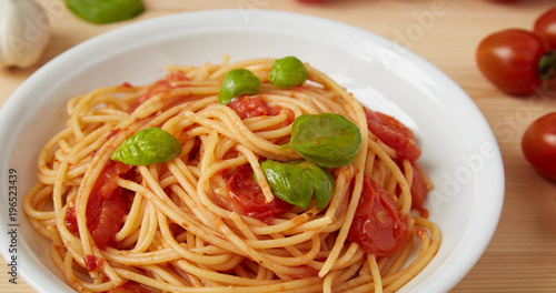 spaghetti with tomato sauce dish on a wood table