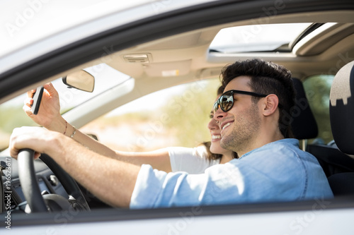 Couple taking selfie on a long drive © AntonioDiaz