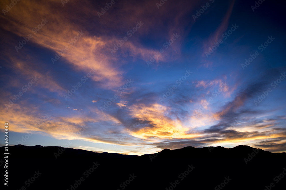 Clouds above Buena Vista, Colorado reflect the colors of the sunrise over the Collegiate Peaks.