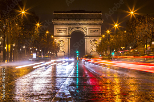 Long exposure shot of traffic racing down the Champs Elysees in Paris, France around the Arc de Triomphe © Chris