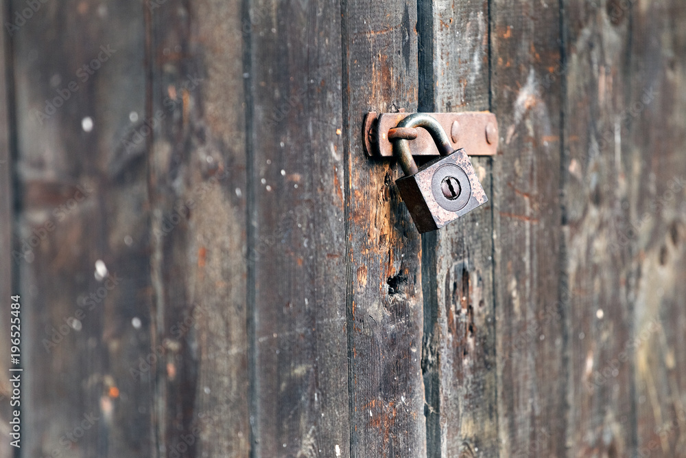 Old rusty padlock on wooden gate Old rusty padlock on wooden gate