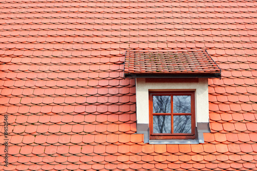 Red shingles on the roof with window