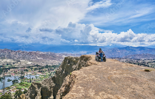 Mother and sons beside quad bike, on mountain top, La Paz, Bolivia, South America