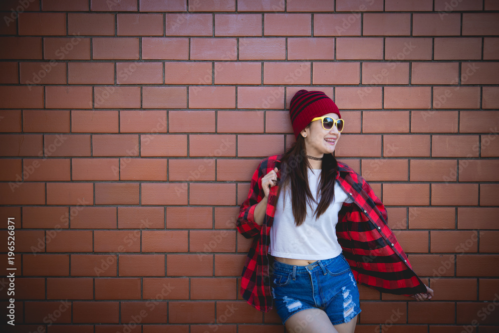 Portrait asian hipster girl on brick wall background,Lifestyle of thailand people Portrait asian hipster girl on brick wall background,Lifestyle of thailand people