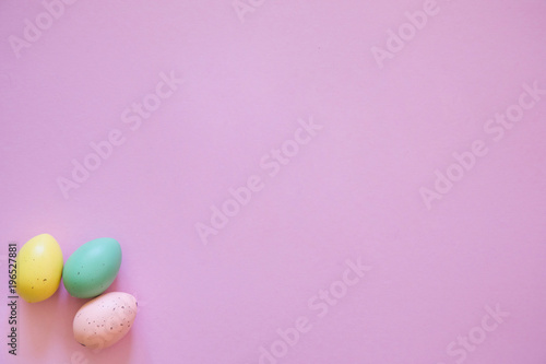 Colorful easter eggs on pink background, easter symbols