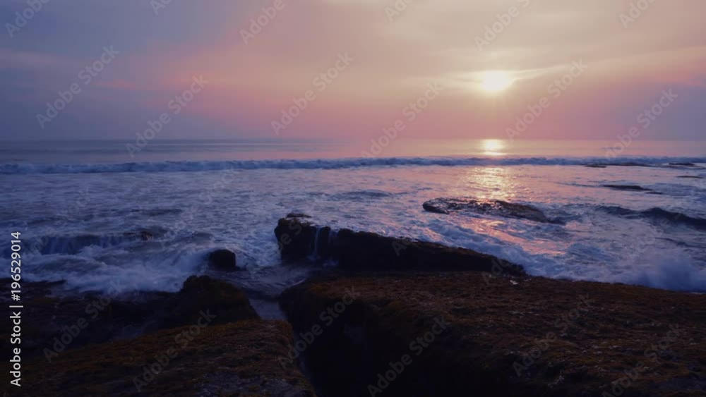 Amazing view sunset on the ocean beach on Bali island, waves, sky, rocks, video 4K with camera stabilizer, wonderful colors Amazing view sunset on the ocean beach on Bali island, waves, sky, rocks, video 4K with camera stabilizer, wonderful colors