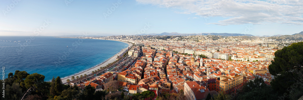 High resolution panorama of mediterranean sea and city of Nice with its red roofs and sky with clouds in background on December day. Nice, France