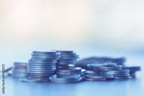 Row of coins on wood background for finance and Saving concept,Investment, Economy, Soft focus and dark style.