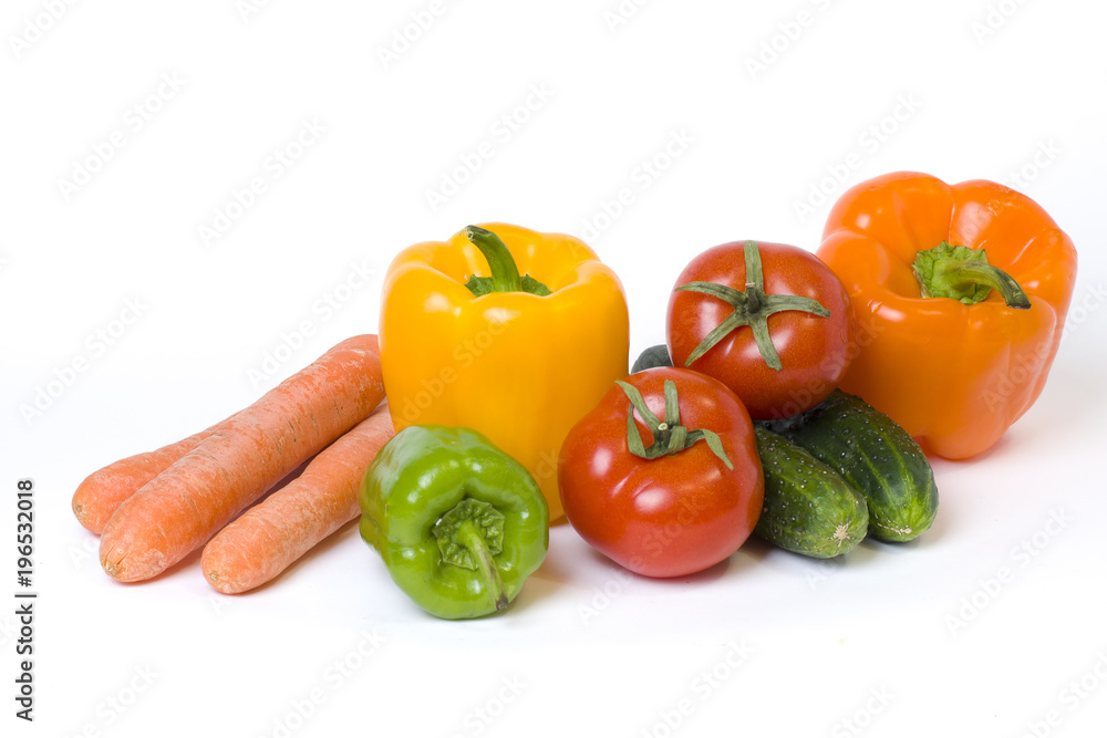 Red yellow and orange peppers with tomatoes on a white background. Cucumbers with colorful peppers in composition on a white background.. Red yellow and orange peppers with tomatoes on a white background. Cucumbers with colorful peppers in composition on a white background..