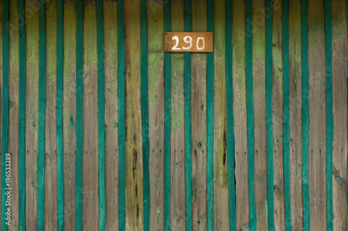 green wooden background with plate number