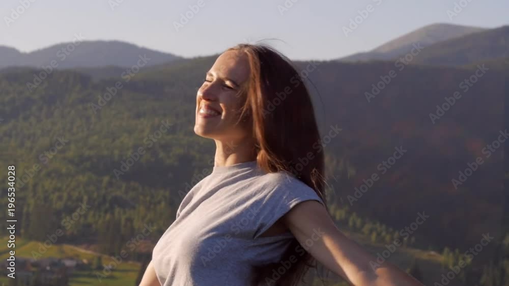 Happy woman spinning at sunset in mountains Happy woman spinning at sunset in mountains