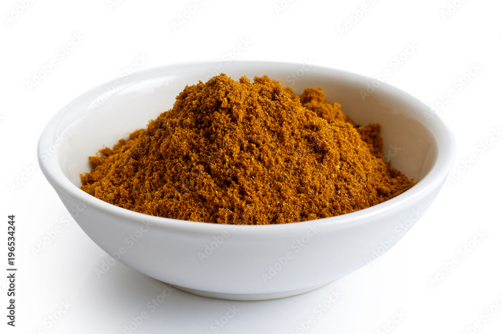 Ground masala spice mix in white ceramic bowl isolated on white. Ground masala spice mix in white ceramic bowl isolated on white.