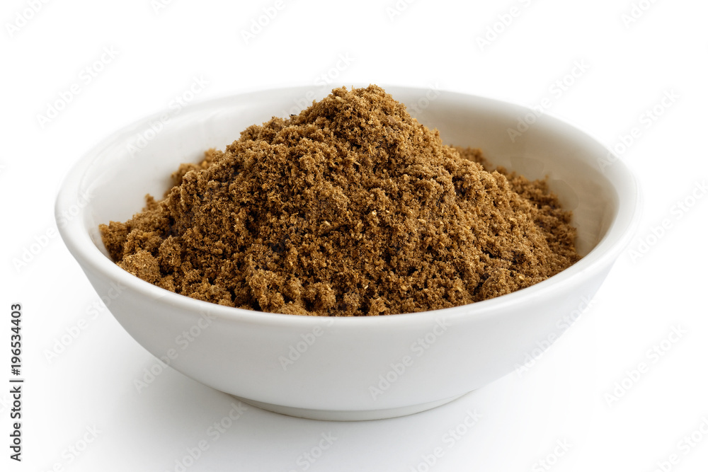 Ground coriander seeds in white ceramic bowl isolated on white. Ground coriander seeds in white ceramic bowl isolated on white.