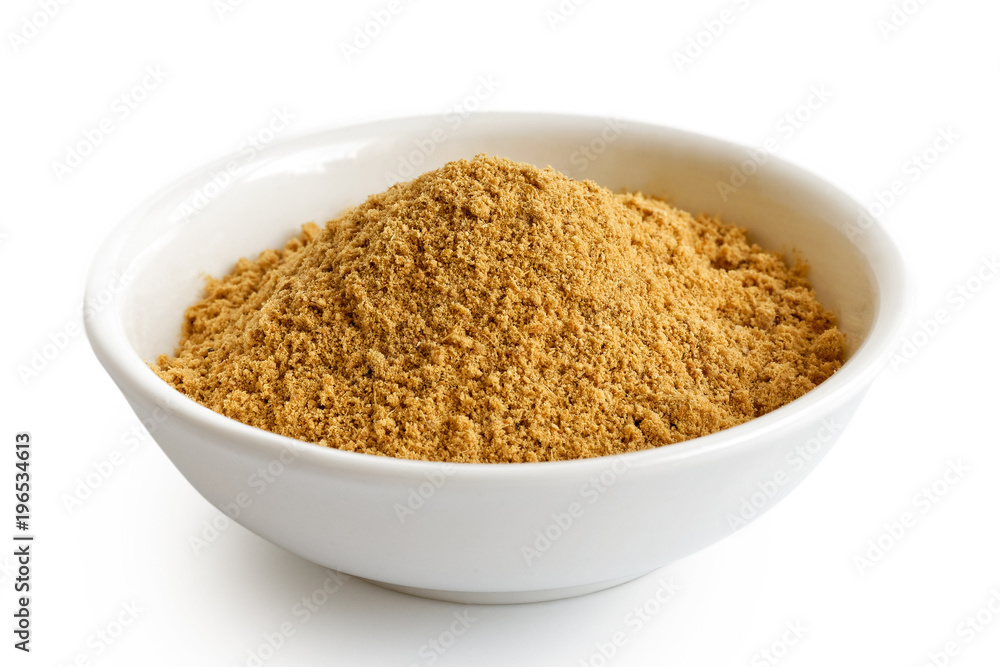 Finely ground dry ginger in white ceramic bowl isolated on white. Finely ground dry ginger in white ceramic bowl isolated on white.