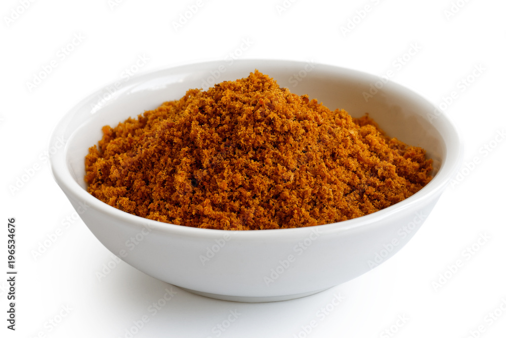 Ground dry mace in white ceramic bowl isolated on white. Ground dry mace in white ceramic bowl isolated on white.