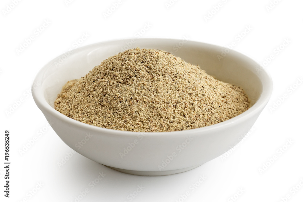 Finely ground white pepper in white ceramic bowl isolated on white. Finely ground white pepper in white ceramic bowl isolated on white.