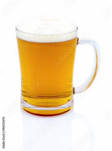 Mug of beer with foam isolated on white background with shadow reflection. Half a liter of beer in glass on white backdrop. Ale in bock. A pint of beer.