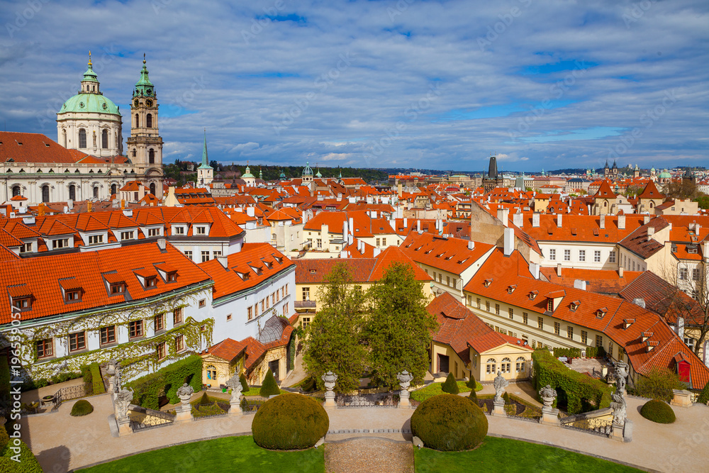 PRAGUE, CZECH REPUBLIC - APRIL 26, 2017: Vrtba garden (Vrtbovska zahrada) and view on old church. PRAGUE, CZECH REPUBLIC - APRIL 26, 2017: Vrtba garden (Vrtbovska zahrada) and view on old church.