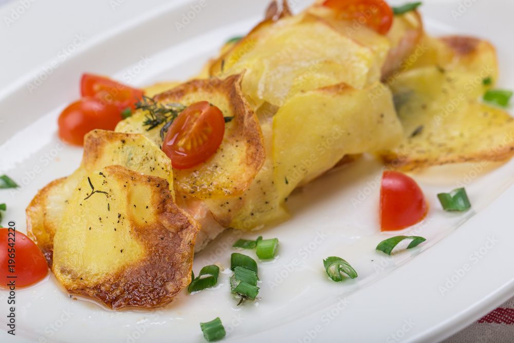 Fish in baked potatoes decorated with cherry tomatoes Fish in baked potatoes decorated with cherry tomatoes