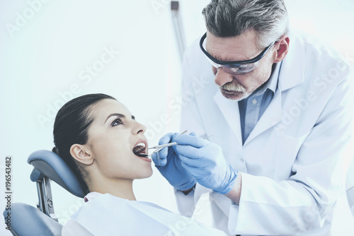 Dentist examining a patient's teeth in the dentist