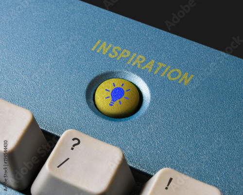 Inspiration conceptual key on computer keyboard in a workplace. To signify the need for a lightbulb moment, lateral thinking idea, to solve problem, brainstorm, enlighten