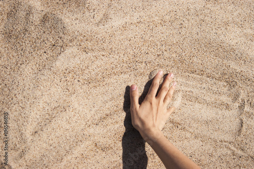 Background with hand on the sand