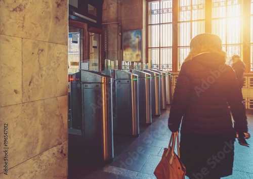 people at the exit of the metro near turnstiles