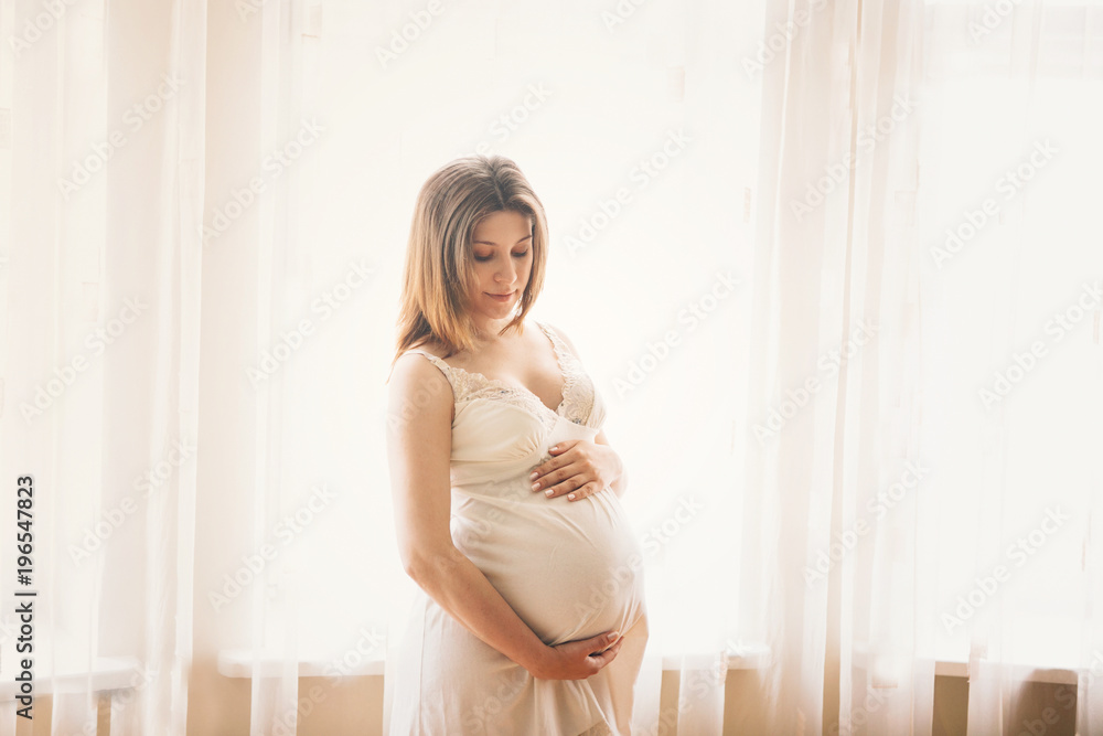 Pregnant woman. at home. Relaxation.. Stay near window.. Pregnant woman. at home. Relaxation.. Stay near window..