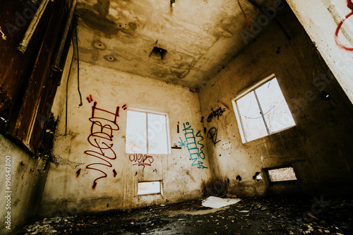 Abandoned farm building with graffiti on the wall