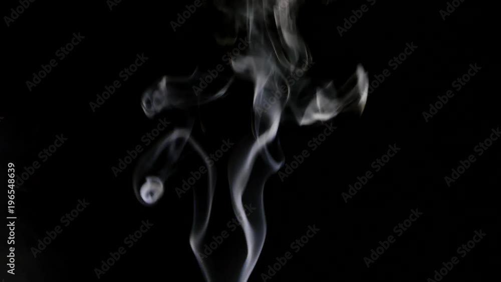 Beautiful gray smoke on a black background. Cigarette smoke. Smoke from the hookah. Turbulence of smoke. The white vapor rises. The smoke slowly flies. Beautiful gray smoke on a black background. Cigarette smoke. Smoke from the hookah. Turbulence of smoke. The white vapor rises. The smoke slowly flies.